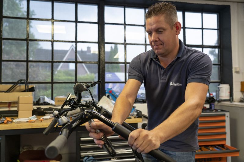 Een man aan het werk aan het stuur van een fiets